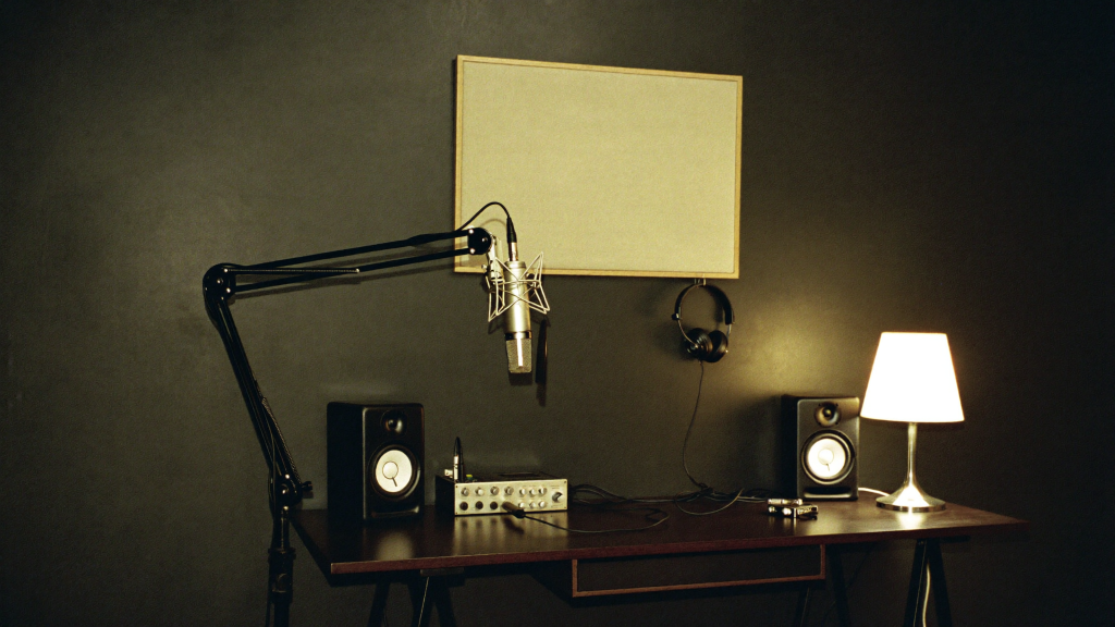 The Complete Home Studio Setup Under $1,000 (2026) 4 Home studio corner with a microphone on a boom arm, audio interface, monitors, headphones and an acoustic panel